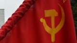KYRGYZSTAN -- A woman holds a flag of the USSR during a rally of Kyrgyz communist supporters to pay their respects to Soviet Union founder and revolutionary leader Vladimir Lenin to mark the 151st anniversary of his birth, in central Bishkek, April 22, 20